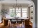 Dining room features a long wooden table and modern chandelier at 22 Collier Nw Rd # 9, Atlanta, GA 30309