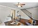 Bright living room with modern decor, hardwood floors, and a staircase at 29 La Rue Nw Pl, Atlanta, GA 30327
