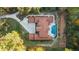 An aerial view shows the expansive red-roofed home surrounded by a large lot and a pristine pool at 1416 Walcutts Nw Way, Marietta, GA 30064