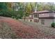 A view of the backyard highlighting the home's exterior and its landscaping on a large lot at 1416 Walcutts Nw Way, Marietta, GA 30064