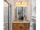 Bathroom with a marble countertop vanity, modern lighting, and glass enclosed shower at 1416 Walcutts Nw Way, Marietta, GA 30064