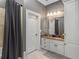 Bathroom with a marble countertop vanity, modern lighting, and shower at 1416 Walcutts Nw Way, Marietta, GA 30064