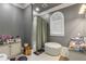 Bathroom with a tufted ottoman and arched window with natural light at 1416 Walcutts Nw Way, Marietta, GA 30064