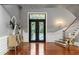 Grand foyer with gleaming wood floors, staircase, and decorative iron front door at 1416 Walcutts Nw Way, Marietta, GA 30064