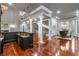 The great room boasts hardwood floors, classic columns, a wet bar, and modern lighting at 1416 Walcutts Nw Way, Marietta, GA 30064