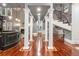 Elegant hallway with decorative columns, hardwood floors, and a view of the staircase at 1416 Walcutts Nw Way, Marietta, GA 30064