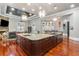 Open-concept kitchen featuring a large island, stone fireplace, and modern appliances at 1416 Walcutts Nw Way, Marietta, GA 30064
