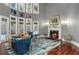 Living room features a cozy fireplace and large windows offering ample natural light and neighborhood views at 1416 Walcutts Nw Way, Marietta, GA 30064