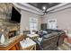 Inviting living area featuring a stone fireplace, leather sofas, and tiger-print rug at 1416 Walcutts Nw Way, Marietta, GA 30064