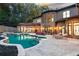Beautiful in-ground pool with adjacent stone patio and outdoor seating area for luxury living at 1416 Walcutts Nw Way, Marietta, GA 30064