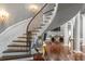 Grand curved staircase with iron railings and gleaming hardwood floors at 1416 Walcutts Nw Way, Marietta, GA 30064