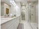 Bright bathroom with double vanity sinks, a walk-in shower, and marble flooring at 2341 Brissett Ln, Brookhaven, GA 30319