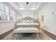 Spacious bedroom featuring an accent rug, tray ceiling, and a seating bench at 2341 Brissett Ln, Brookhaven, GA 30319