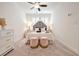 Bright bedroom with two windows and a statement leopard print headboard and plush pink ottomans at 2341 Brissett Ln, Brookhaven, GA 30319