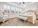 Bright main bedroom boasts tray ceilings, stylish furnishings, and plenty of natural light at 2341 Brissett Ln, Brookhaven, GA 30319