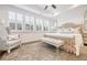 Bright main bedroom boasts tray ceilings, stylish furnishings, and plenty of natural light at 2341 Brissett Ln, Brookhaven, GA 30319