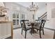 Elegant dining room featuring a chandelier, natural light and direct staircase access at 2341 Brissett Ln, Brookhaven, GA 30319
