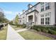 Inviting street view of townhomes featuring lush landscaping, sidewalks and stately architecture at 2341 Brissett Ln, Brookhaven, GA 30319