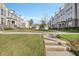 Well-manicured front lawn and landscaping in front of stately townhomes with beautiful architectural details at 2341 Brissett Ln, Brookhaven, GA 30319