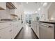 Modern kitchen featuring stainless steel appliances, stylish backsplash, and white cabinetry at 2341 Brissett Ln, Brookhaven, GA 30319