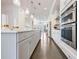 Open kitchen design with dark floors, white cabinets, and modern stainless steel appliances at 2341 Brissett Ln, Brookhaven, GA 30319