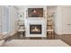 Bright living room showcasing a modern fireplace with white mantel, flanked by stylish shelving and dark hardwood floors at 2341 Brissett Ln, Brookhaven, GA 30319