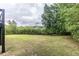 Backyard has trees and a fire pit at 3950 Yancey Rd, Douglasville, GA 30135