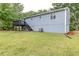 Backyard showing walk out access from lower level and deck above at 3950 Yancey Rd, Douglasville, GA 30135