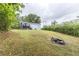 Wide shot of a large backyard with deck, walkout basement, and stone fire pit at 3950 Yancey Rd, Douglasville, GA 30135