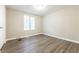 Bedroom featuring neutral walls, modern flooring, and a window bringing in light at 3950 Yancey Rd, Douglasville, GA 30135