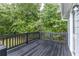 Wooden deck overlooking the yard of the home, and green trees at 3950 Yancey Rd, Douglasville, GA 30135