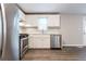 Updated kitchen featuring stainless steel appliances, white cabinets, and gray counter tops at 3950 Yancey Rd, Douglasville, GA 30135