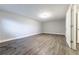 Large empty room featuring gray walls, modern floors, and a side door at 3950 Yancey Rd, Douglasville, GA 30135