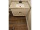 Bathroom featuring a granite countertop vanity with white cabinets and a black faucet, complemented by hardwood flooring at 724 Vinson Mountain Crossing Rd, Rockmart, GA 30153