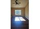 The bedroom has ample natural light from a large window and features modern ceiling fan and hardwood floors at 724 Vinson Mountain Crossing Rd, Rockmart, GA 30153