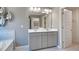 Double vanity bathroom with modern gray cabinets and a large mirror at 583 Princeton Elm Pl, Lawrenceville, GA 30045