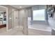 Elegant bathroom with a soaking tub and walk-in shower at 583 Princeton Elm Pl, Lawrenceville, GA 30045