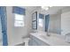 Clean bathroom with gray vanity and blue shower curtain at 583 Princeton Elm Pl, Lawrenceville, GA 30045