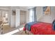 Bedroom with red bedding and a spacious closet at 583 Princeton Elm Pl, Lawrenceville, GA 30045