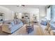 Open living room features a neutral color palette, plush sofas, and a large area rug at 583 Princeton Elm Pl, Lawrenceville, GA 30045