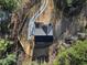 Overhead shot of a home featuring dark roof, surrounded by trees, and a winding driveway on a large lot at 3785 Pilgrim Mill Rd, Cumming, GA 30041