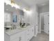 Bathroom with double sink vanity, a window, and a soaking tub at 3785 Pilgrim Mill Rd, Cumming, GA 30041