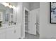 Bathroom featuring white cabinets, double vanity and a large storage closet at 3785 Pilgrim Mill Rd, Cumming, GA 30041