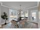 Elegant dining area with a modern light fixture and view to the backyard at 3785 Pilgrim Mill Rd, Cumming, GA 30041