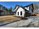 Newly built two-story home boasting a modern farmhouse design, accented with black trim and board siding at 3785 Pilgrim Mill Rd, Cumming, GA 30041