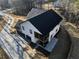 Aerial view of a newly constructed two-story home with a three-car garage and a screened-in porch at 3785 Pilgrim Mill Rd, Cumming, GA 30041