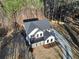 Aerial view of a charming farmhouse-style home surrounded by tall trees and featuring a modern design at 3785 Pilgrim Mill Rd, Cumming, GA 30041