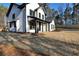 Beautiful two-story home with board siding, black trim, a covered porch and a large front yard at 3785 Pilgrim Mill Rd, Cumming, GA 30041