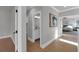 This hallway leads to a bedroom and bathroom, with light hardwood floors and neutral walls at 3785 Pilgrim Mill Rd, Cumming, GA 30041