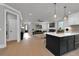 Bright open kitchen featuring white cabinets, island with barstool seating, and stainless appliances at 3785 Pilgrim Mill Rd, Cumming, GA 30041